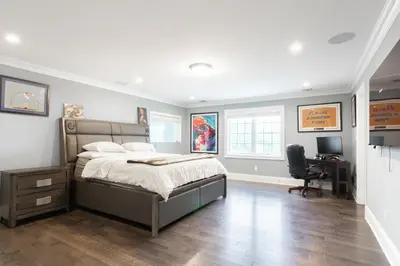 a bedroom with a bed and a desk in it at Luxury 4BR Magical Oasis Villa Mansion with Indoor Basketball Court and Gym in Melville