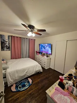 a bedroom with two beds and a flat screen tv at Clientele in North Bergen