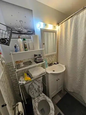 a bathroom with a toilet and a sink at Clientele in North Bergen