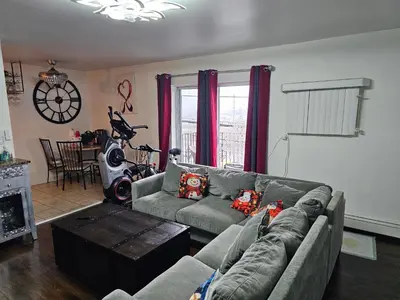 a living room with a couch and a table at Clientele in North Bergen