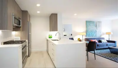 a kitchen and a living room with a couch at Cameo in New York