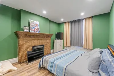 a bedroom with a bed and a fireplace at Spacious Home In Troy in Troy