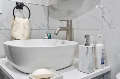 a bathroom sink with a white bowl bowl sink at Spacious Home In Troy in Troy