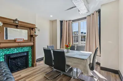 a dining room with a table and a fireplace at Spacious Home In Troy in Troy