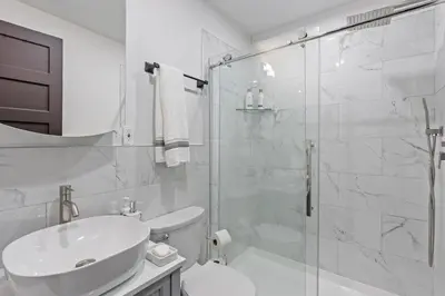 a bathroom with a shower and a toilet and a sink at Spacious Home In Troy in Troy