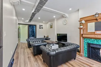 a living room with leather furniture and a fireplace at Spacious Home In Troy in Troy
