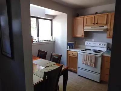 a kitchen with a table and a white stove top oven at Farmington Guest Housing in Farmington