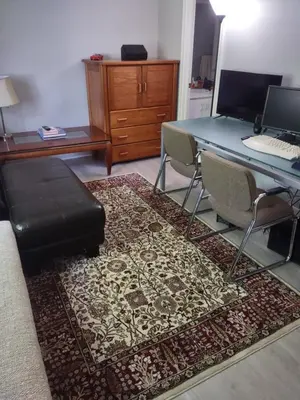 a room with a desk and a table with a laptop at Farmington Guest Housing in Farmington