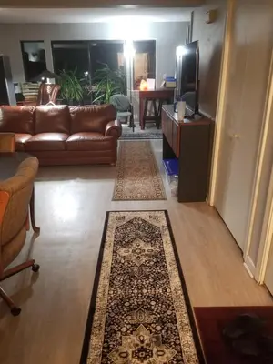 a living room with a couch and a television at Farmington Guest Housing in Farmington