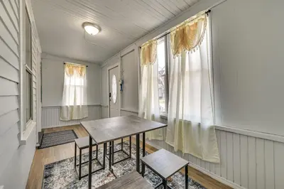 a dining room with a table and two chairs at Walk to Local Eats! Updated Schenectady Apartment in Schenectady