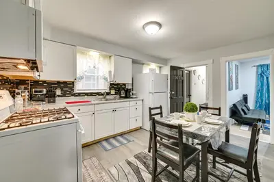 a kitchen with a table and a dining room at Walk to Local Eats! Updated Schenectady Apartment in Schenectady