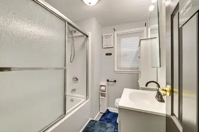 a bathroom with a shower and a sink and a toilet at Walk to Local Eats! Updated Schenectady Apartment in Schenectady