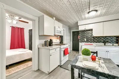 a kitchen with a table and a bed in a room at 2 Mi to Union College! Newly Renovated Apartment in Schenectady