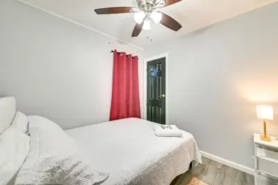 a bedroom with a bed and a ceiling fan at 2 Mi to Union College! Newly Renovated Apartment in Schenectady