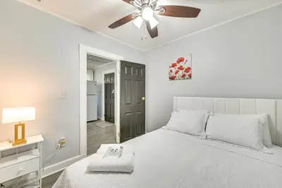 a white bedroom with a bed and a ceiling fan at 2 Mi to Union College! Newly Renovated Apartment in Schenectady