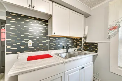 a kitchen with white cabinets and a sink at 2 Mi to Union College! Newly Renovated Apartment in Schenectady