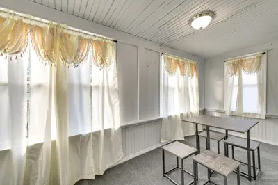 a room with curtains and a table and two chairs at 2 Mi to Union College! Newly Renovated Apartment in Schenectady