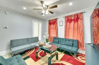 a living room with two blue couches and a table at 2 Mi to Union College! Newly Renovated Apartment in Schenectady