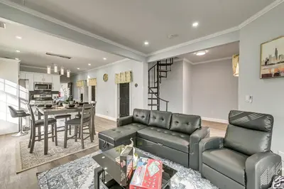 a living room with a couch and a table at Walk to Park Modern Apt 2 Mi to Union College! in Schenectady