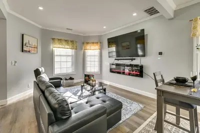 a living room with a couch and a table at Walk to Park Modern Apt 2 Mi to Union College! in Schenectady