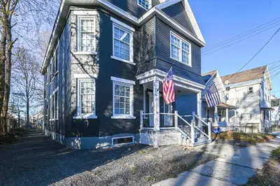 a blue house with an american flag on it at Walk to Park Modern Apt 2 Mi to Union College! in Schenectady
