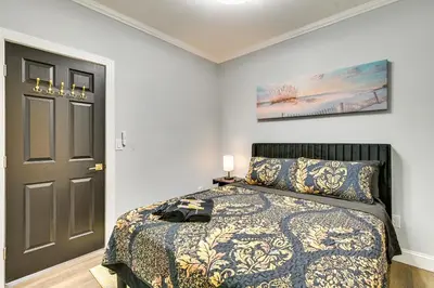 a bedroom with a bed and a black door at 2 Mi to Downtown Charming Apt in Schenectady! in Schenectady