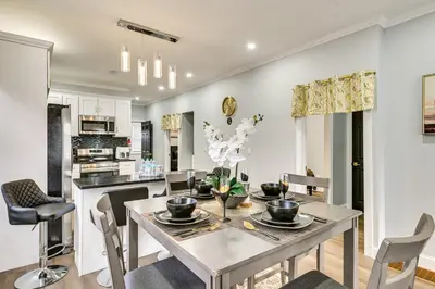 a kitchen and dining room with a table and chairs at 2 Mi to Downtown Charming Apt in Schenectady! in Schenectady