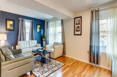 a living room with a couch and a table at 6 Mi to Dtwn New Haven Duplex with Shared Yard in West Haven