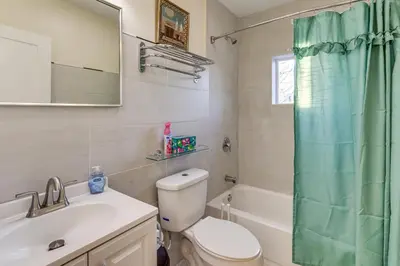 a bathroom with a toilet sink and a shower curtain at 6 Mi to Dtwn New Haven Duplex with Shared Yard in West Haven
