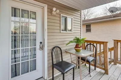 a patio with a table and chairs on a porch at 6 Mi to Dtwn New Haven Duplex with Shared Yard in West Haven