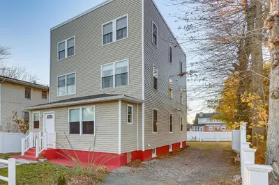 a gray house with a red bottom at 6 Mi to Dtwn New Haven Duplex with Shared Yard in West Haven