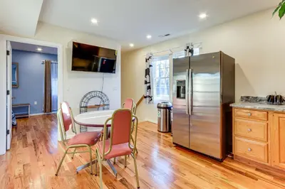 a kitchen with a table and chairs and a refrigerator at 6 Mi to Dtwn New Haven Duplex with Shared Yard in West Haven