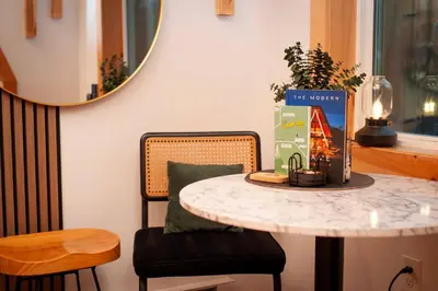 a table and two chairs with a table and a mirror at The A-Frame on Pudding Hill in Stamford