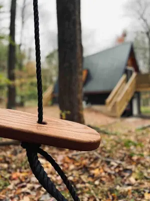 a close up of a wooden swing in a park at The A-Frame on Pudding Hill in Stamford