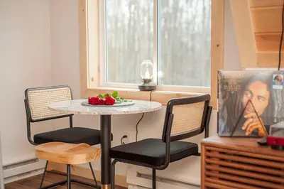a table with two chairs and a plate of fruit on it at The A-Frame on Pudding Hill in Stamford