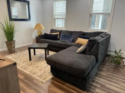 a living room with a couch and a chair at Lovely 2Bed in Newark in Newark