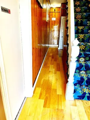 a hallway with a staircase with blue and white stair risers at 3 Bedrooms Huge Apt in LIC, very next to Manhattan in Roosevelt Island