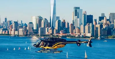a helicopter flying over the water in front of a city at 3 Bedrooms Huge Apt in LIC, very next to Manhattan in Roosevelt Island