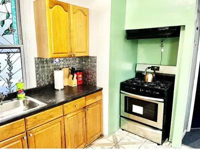 a kitchen with a stove and a sink at 3 Bedrooms Huge Apt in LIC, very next to Manhattan in Roosevelt Island