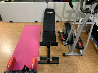 a gym with a bench and a pink mat at Near Seaport In Chinatown in New York