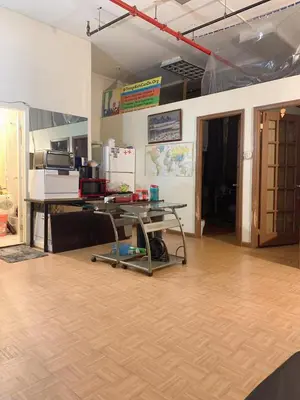 a room with a desk and a table in a room at Near Seaport In Chinatown in New York
