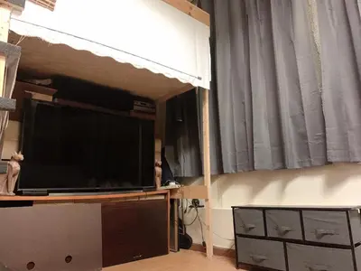 a living room with a large flat screen tv at Near Seaport In Chinatown in New York
