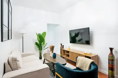 a living room with a couch and a table at Prime location 1BR Newly Furnished in New York