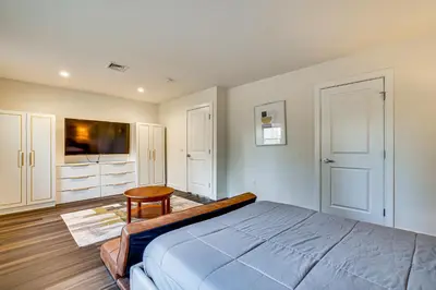 a bedroom with a large bed and a table at Pet-Friendly Group Getaway 12 Mi to Camelback Mtn! in Cresco