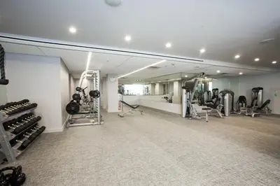a gym with tread machines and a mirror at Central Chelsea 1BR w Gym Doorman NYC-20 in New York