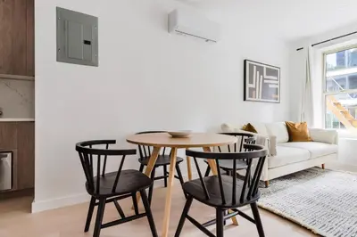 a living room with a table and four chairs at Blueground Midtown East view nr UN Plaza NYC-2126 in New York