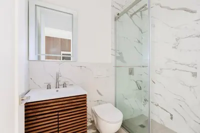 a bathroom with a toilet and a sink and a shower at Blueground Midtown East view nr UN Plaza NYC-2126 in New York