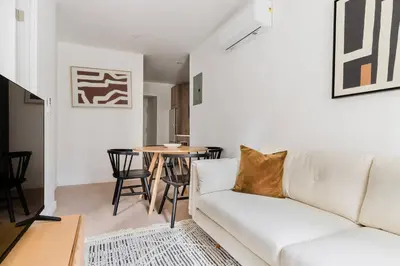 a living room with a white couch and a table at Blueground Midtown East view nr UN Plaza NYC-2126 in New York