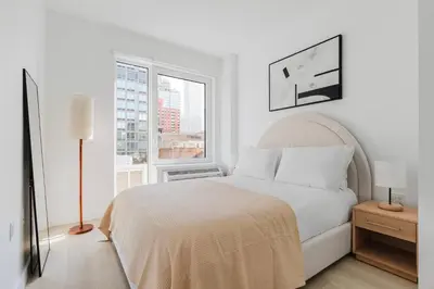 a white bedroom with a bed and a window at Blueground Downtown Brooklyn rooftop nr Brooklyn Bridge NYC-2125 in Brooklyn
