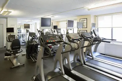 a gym with a bunch of treadmills and machines at Blueground Downtown Brooklyn rooftop nr Brooklyn Bridge NYC-2125 in Brooklyn